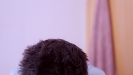 sleepy man waking up and washing face in bathroom