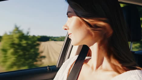woman enjoying scenic views from car window on a road trip