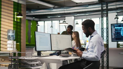 admin in tech startup office using pc, compiling software patches to fix bugs
