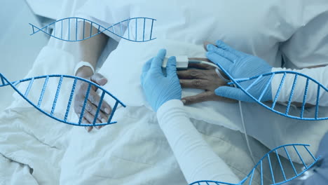 Animation-of-dna-strands-over-diverse-female-doctor-and-patient-in-hospital