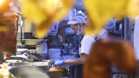 chef skillfully prepares roast duck in busy kitchen