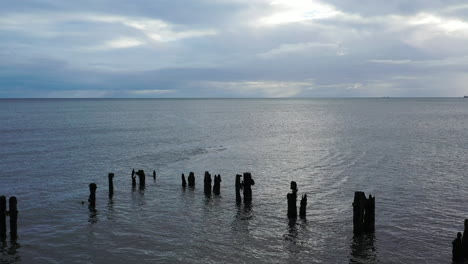 aerial flight slowly moving forward over sea defences, groynes part 2