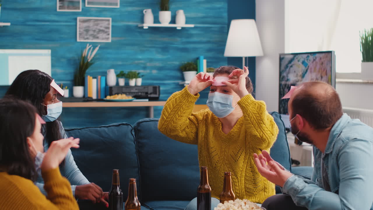 Mixed races friends having fun playing game with sticky notes