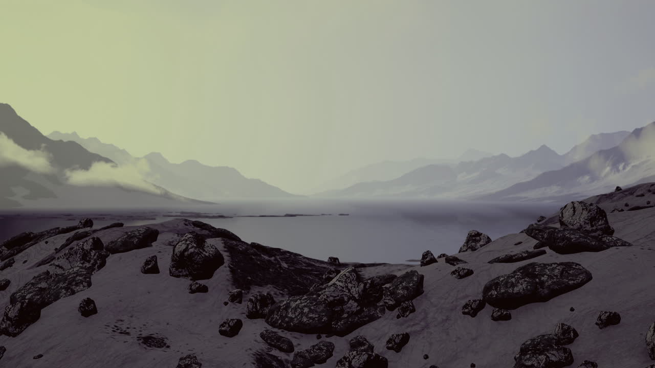 Misty mountains rise above a tranquil lake under soft evening light