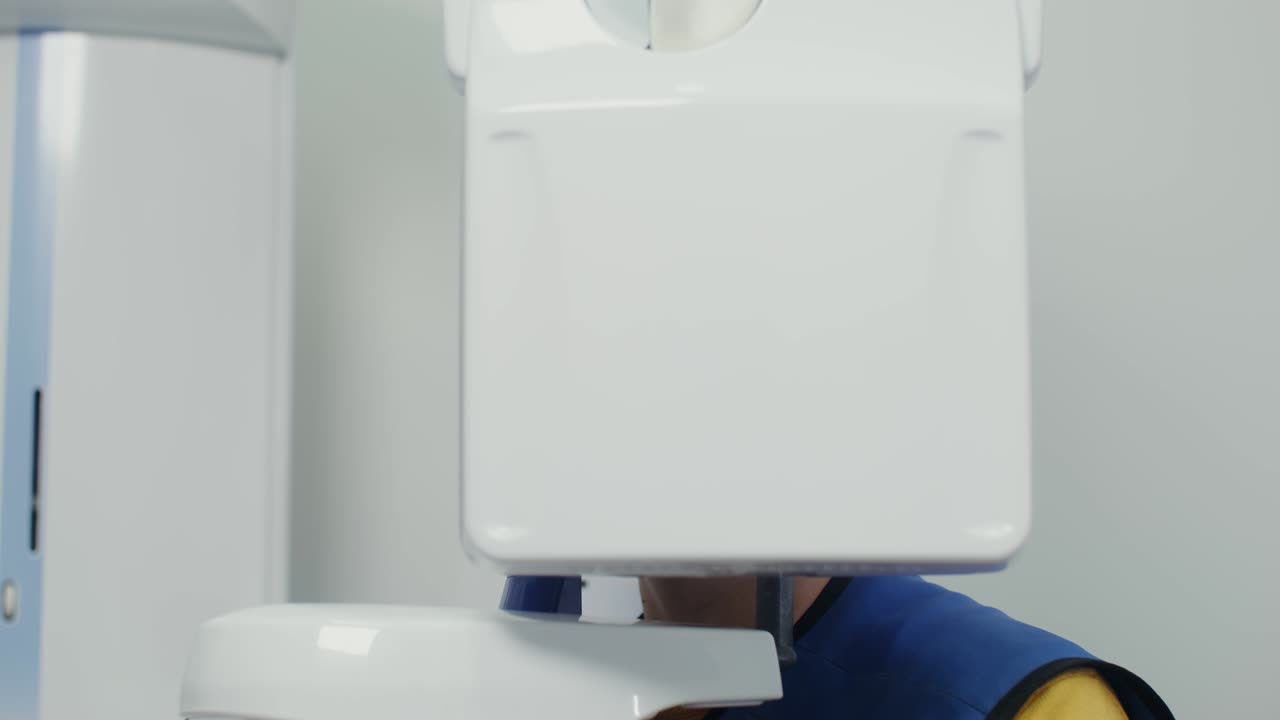 Dental jaw scanning. Patient inside a panoramic 3D dental scanne