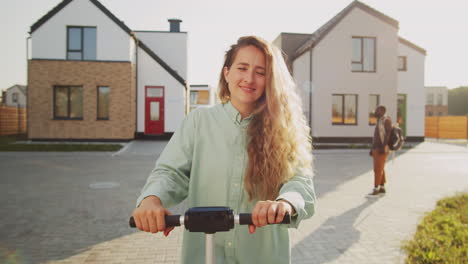 Happy-Woman-Posing-with-E-Scooter-on-Street