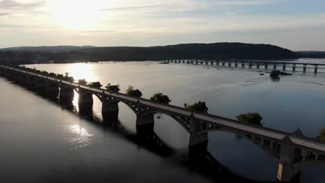 aerial push in shot with traffic crossing susquehanna river bridge, lancaster and york county pennsylvania