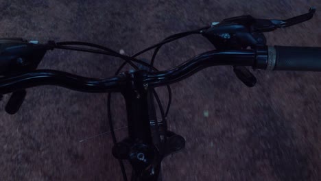 point of view while riding bicycle on paved trail.