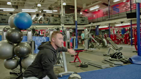 man train on sports training equipment in a fitness gym