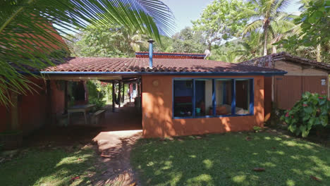 Panning-view-of-bungalows-surrounded-by-a-garden-and-tropical-trees