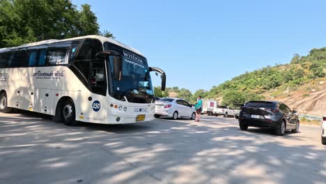 bus navigating around cars in a busy lot