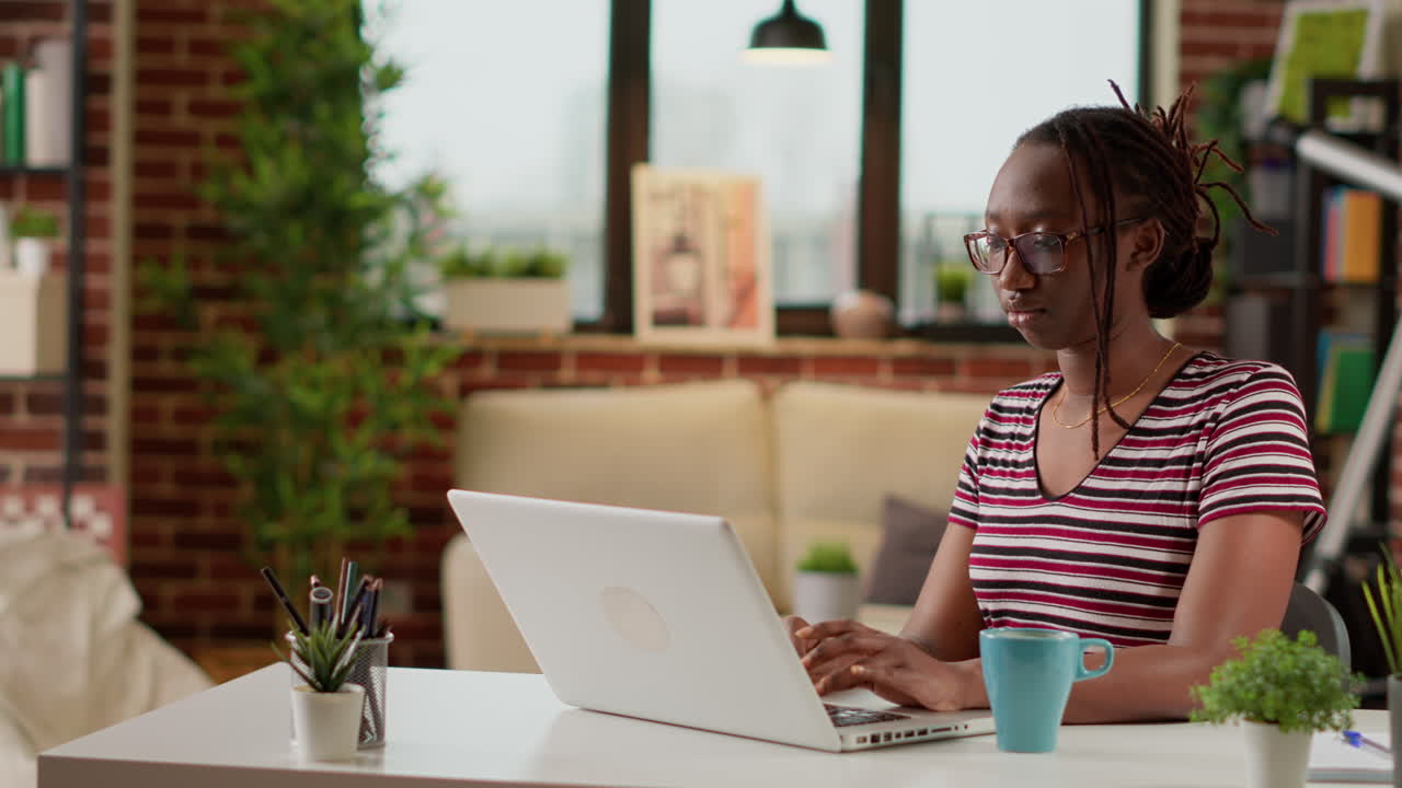 African American woman working on laptop at home office