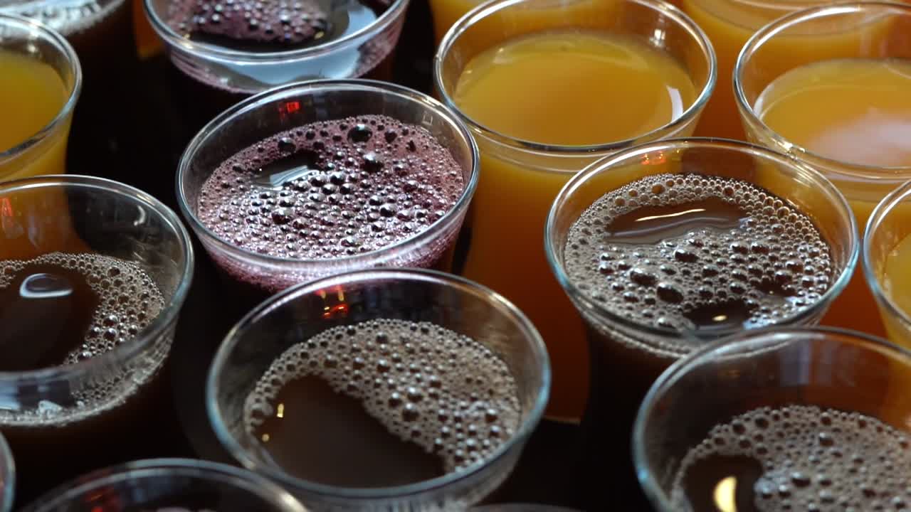 View of drinks in a small plastic cups, close up shot, high angle shot