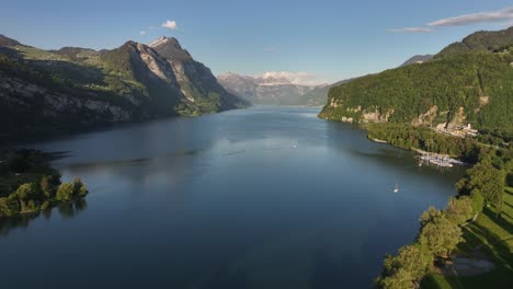 Aerial-view-showcasing-the-beautiful-alpine-scenery-with-Lake-Walensee-nestled-in-the-Swiss-Alps,-Switzerland,-embodying-the-concept-of-breathtaking-natural-beauty-and-serene-tranquility