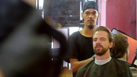 barber showing man his haircut in mirror 4k