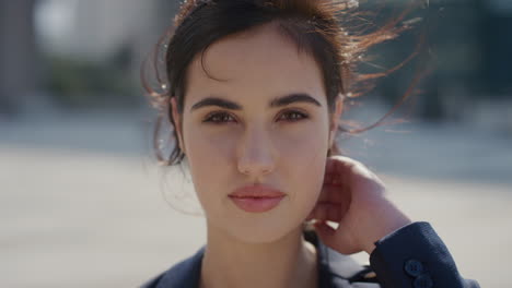 portrait beautiful young business woman smiling running hand through hair looking down vulnerable feminine beauty slow motion wind blowing