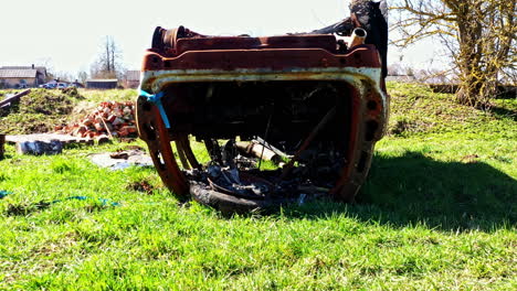 burned undercarriage of flipped car showing fire damage and exposed vehicle components