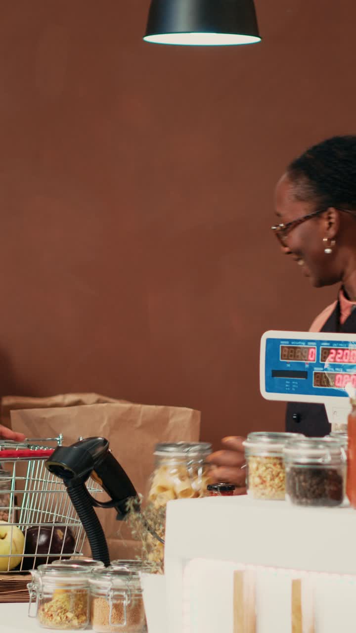 Vertical Video Shopper bringing her natural groceries selection at checkout
