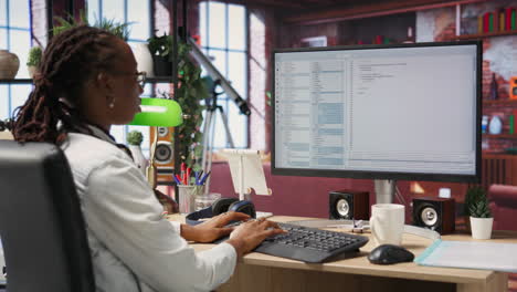 programmer at computer desk coding, creating software