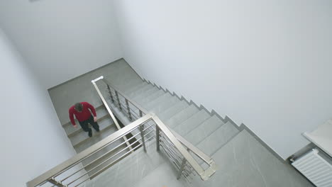 people walking down modern stairs