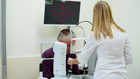 elderly man examined by ophthalmologist. doctor optometrist examining old man eyes with special eye equipment