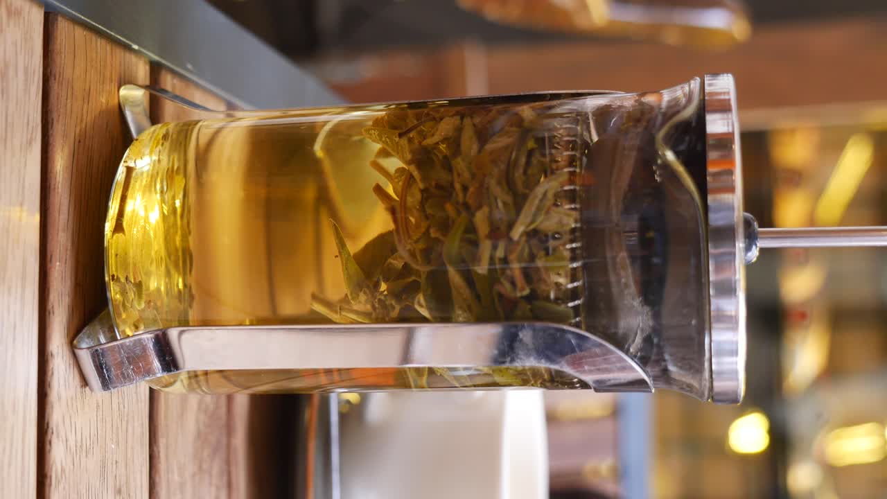 Glass teapot with tea leaves