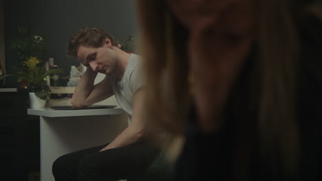couple engaged in a conversation, one reading a book