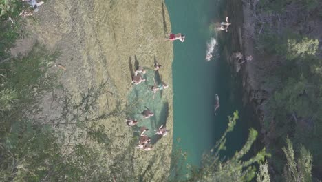 People-on-vacation-relaxing-and-swimming-in-a-tranquil-river-in-Patagonia,-Argentina