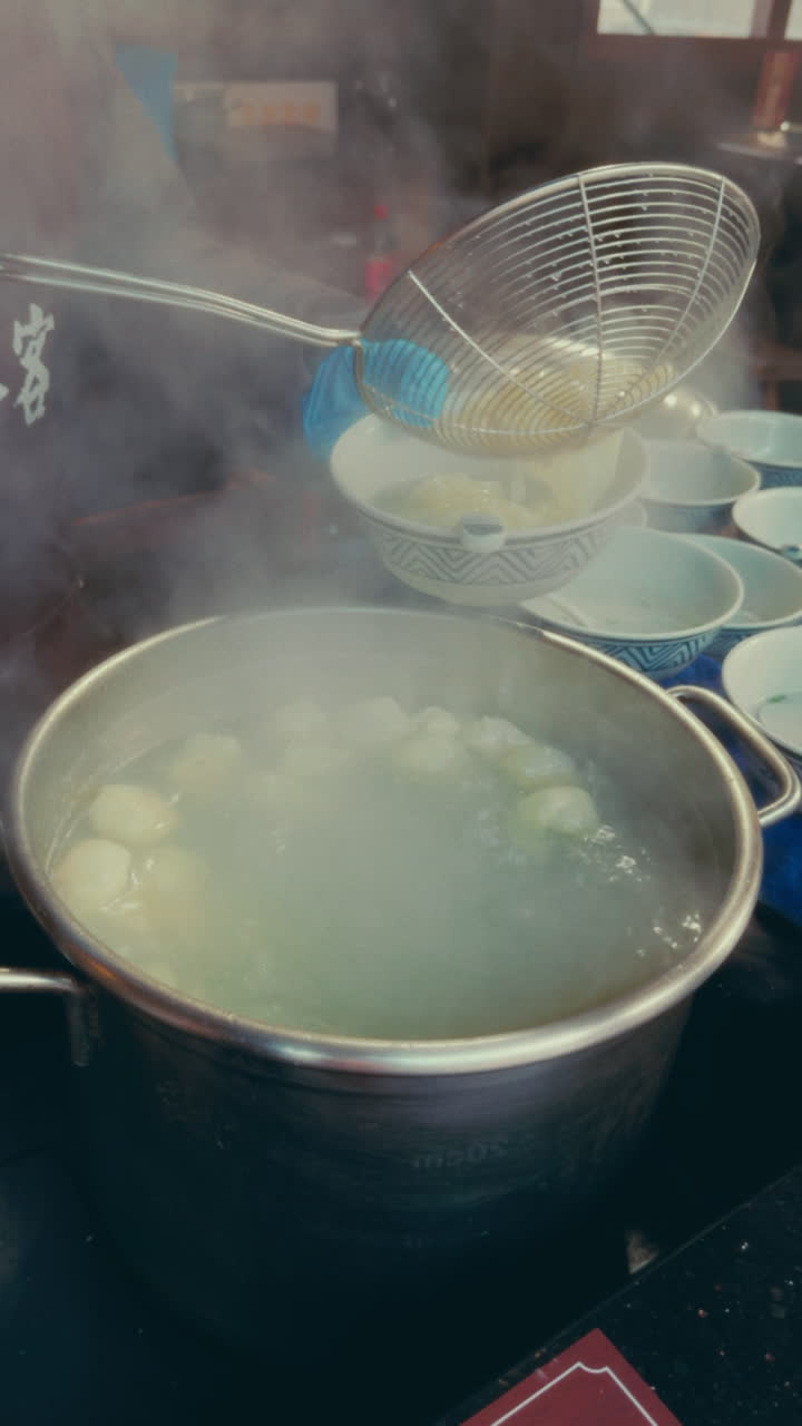 Cooking dumplings in Wuzhen, China, with steam rising from a pot