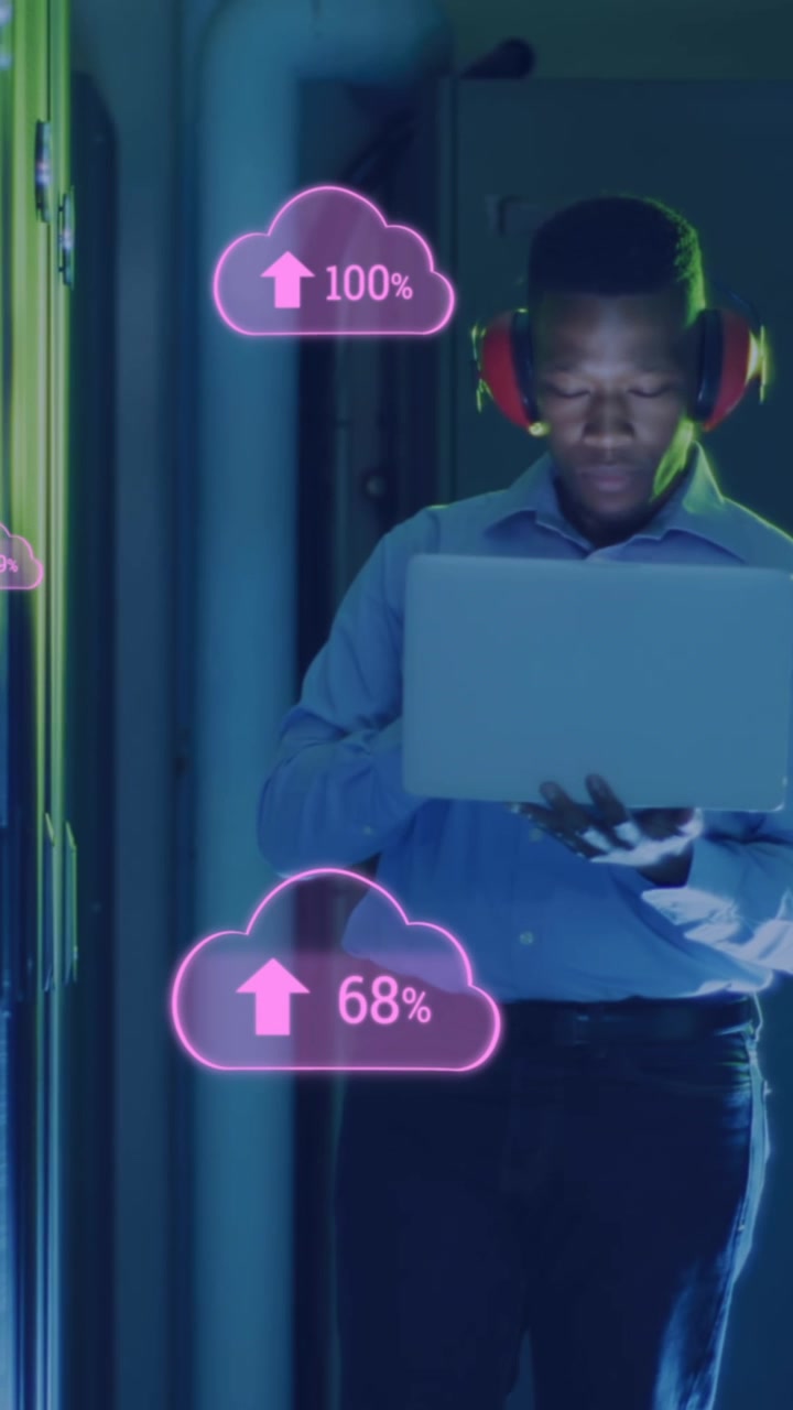 Animation of cloud with uploading over african american man working in server room
