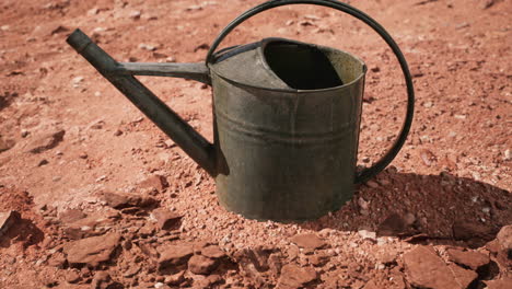 beverage can in sand and rocks desert