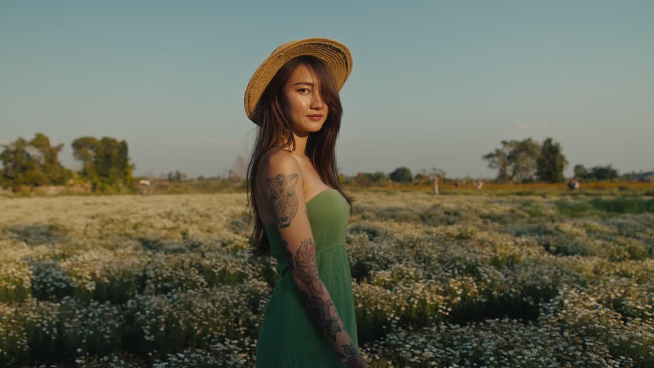 Woman in a straw hat in a flower field