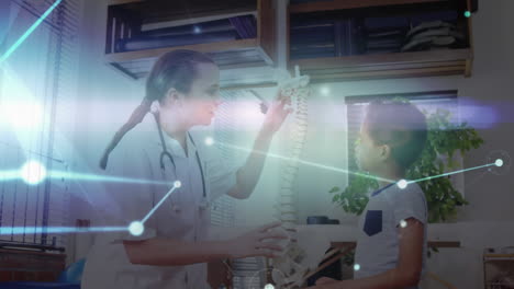digital animation of glowing network of connections moving against female doctor showing human spine