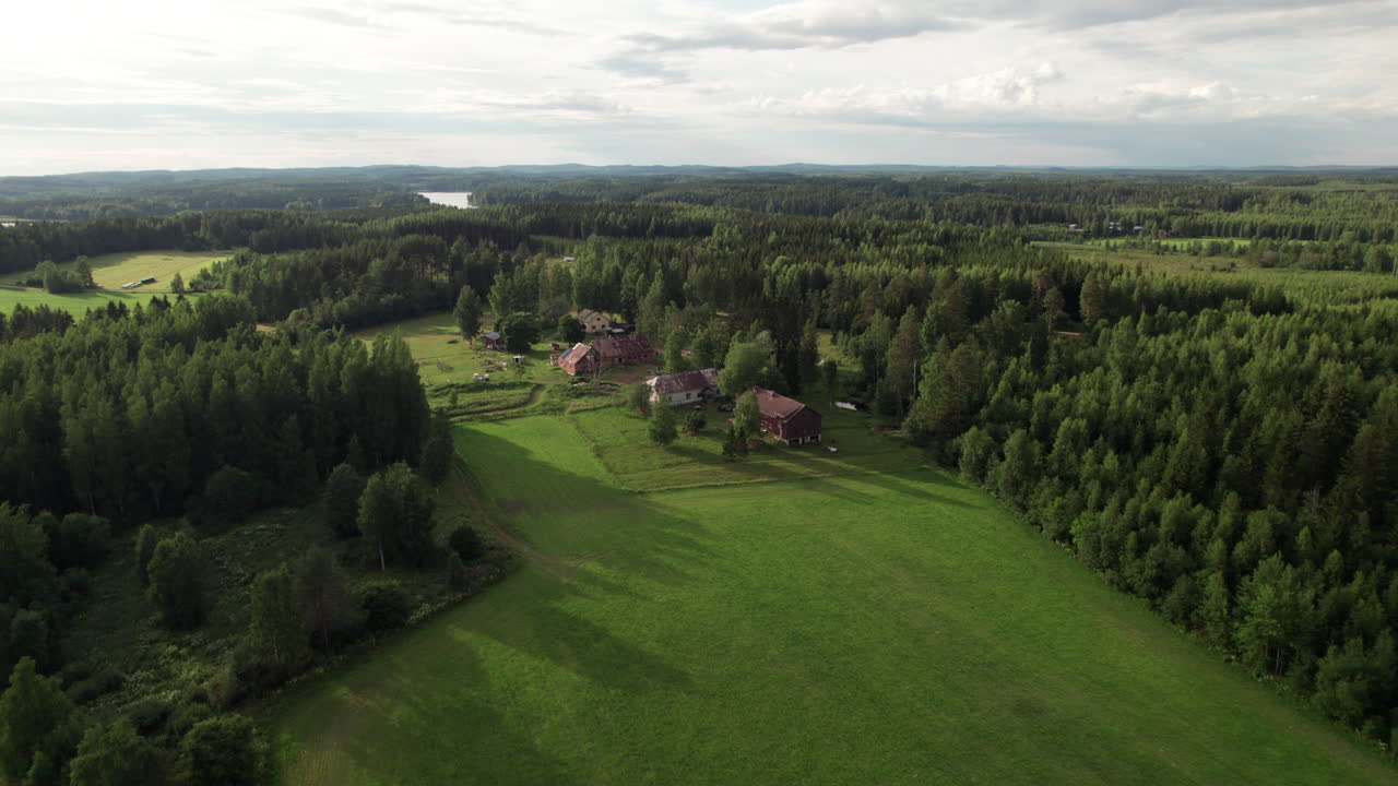 Aerial View of Farm Houses in a beautiful Sunset Atmosphere on the Countryside, Finland, Kuopio, Vehmersalmi, Stunning Forest and Lake Landscape