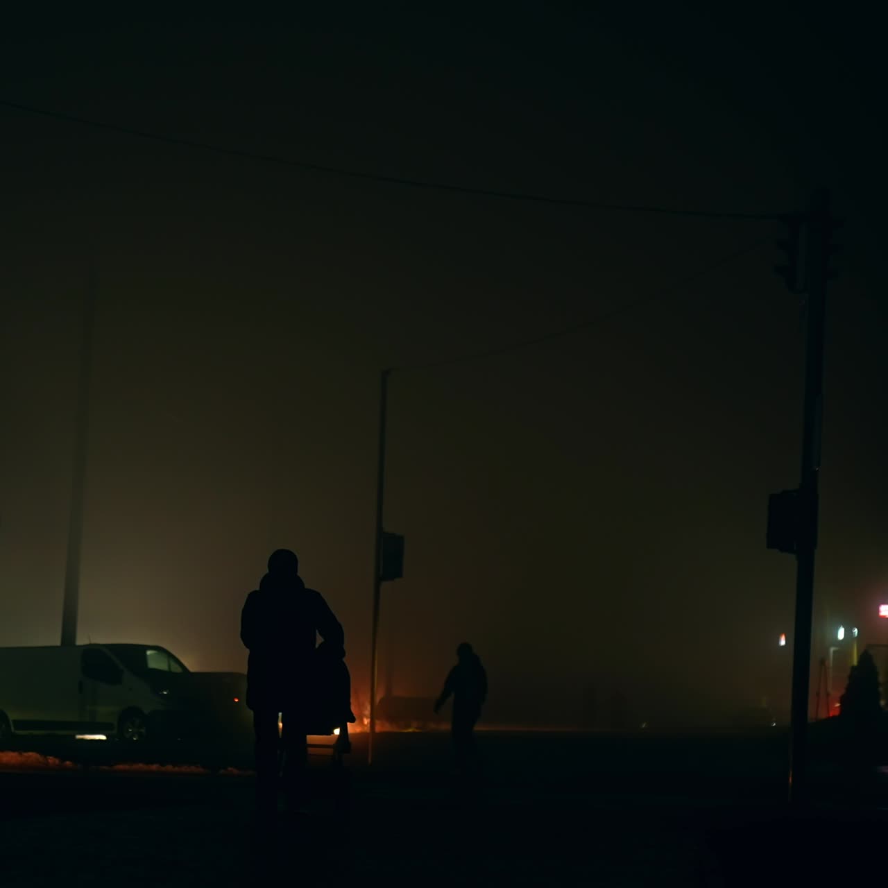 Evening outdoors in the city at blackout time. Transport and people moving in the darkness of the metropolis during power outage