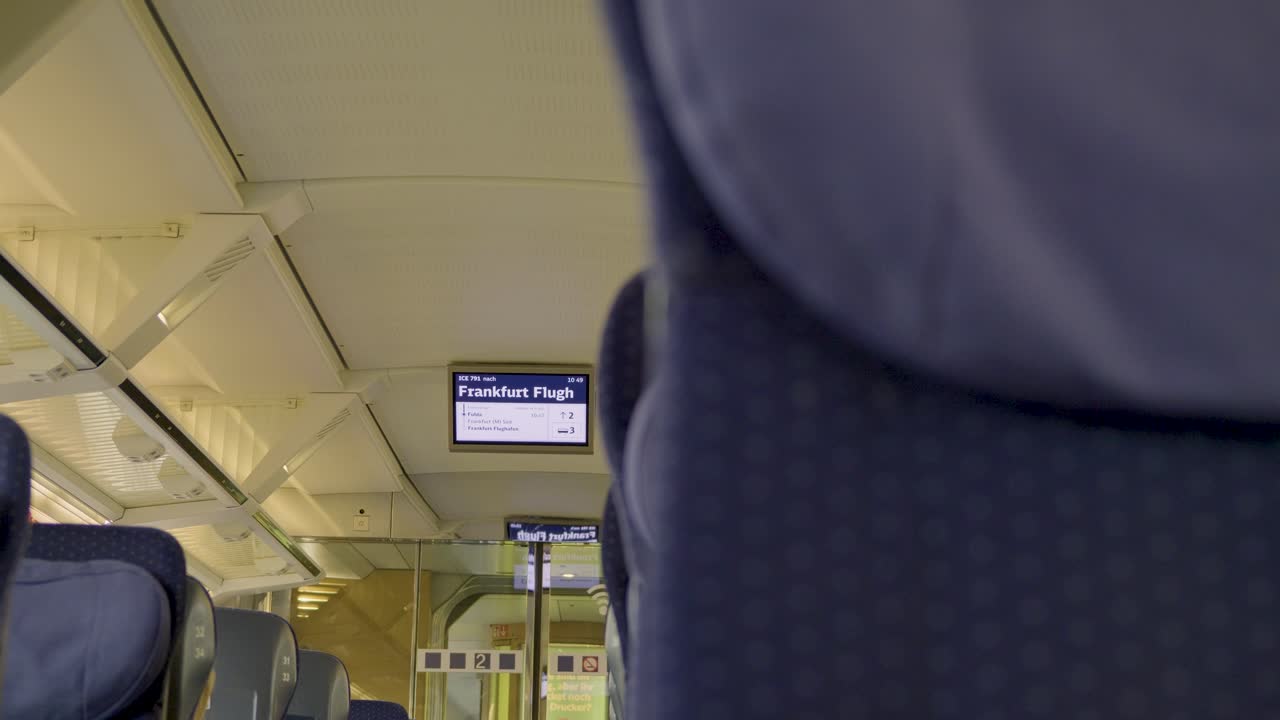 Modern interior of a German ICE train, view of Frankfurt Flughafen station sign