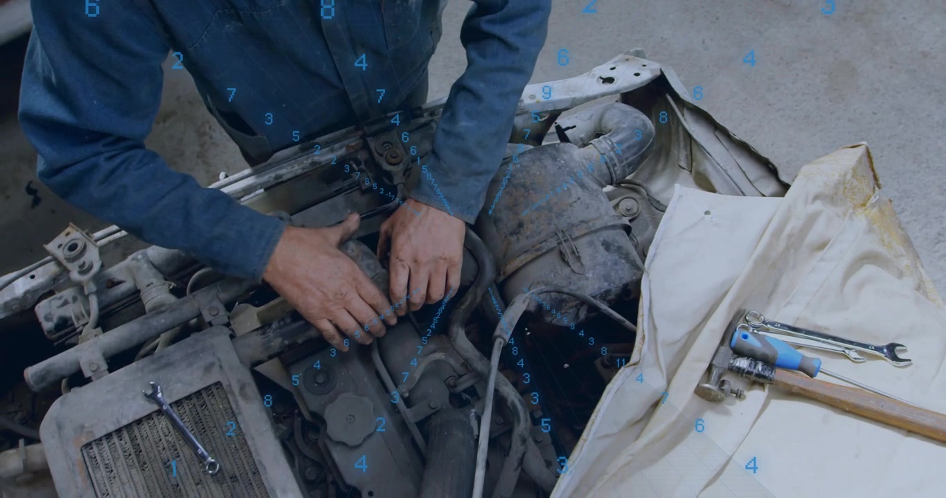 Mechanic reaching into engine bay and tightening hose clamp, securing coupling for repair