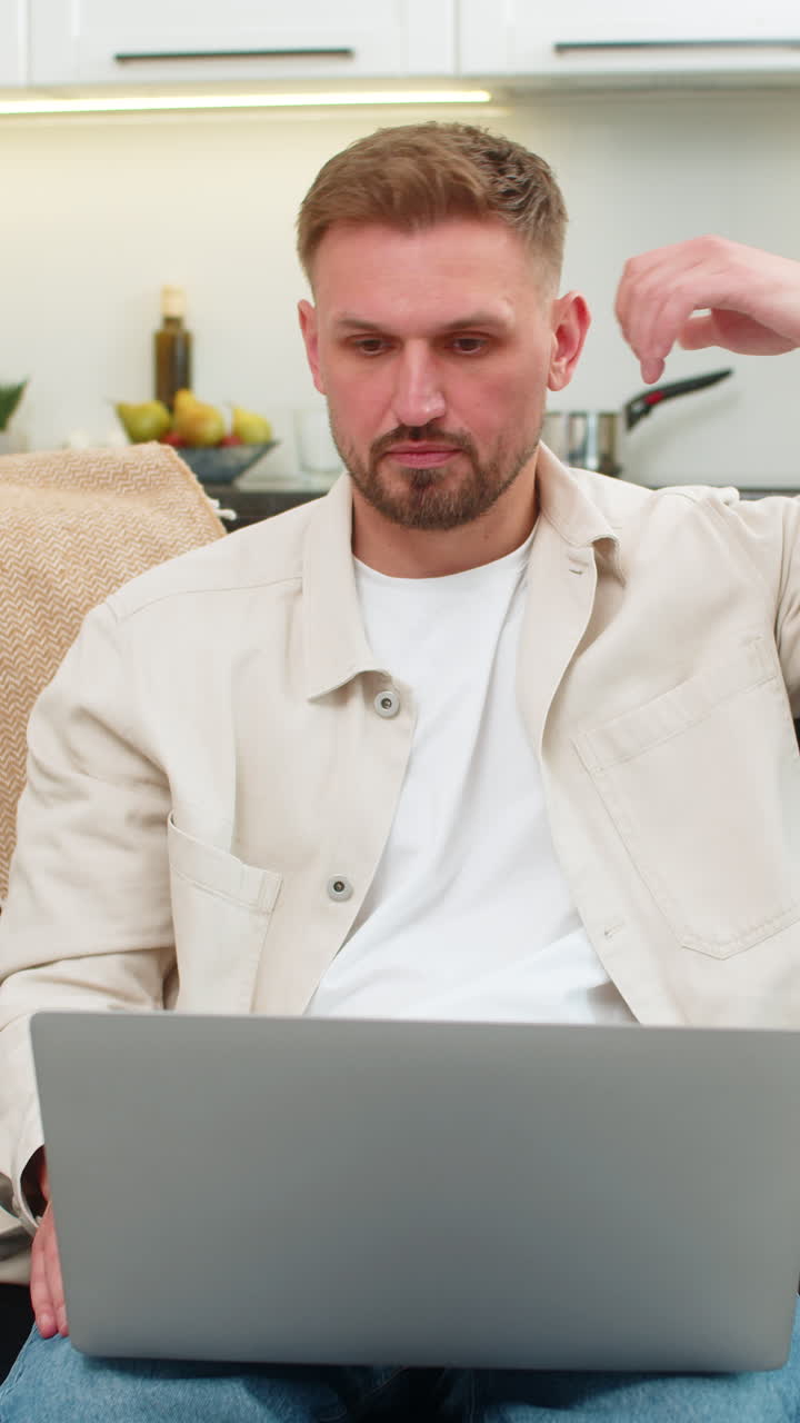 Young man irritated by laptop frozen program virus glitch error tries to fix issue with frustration