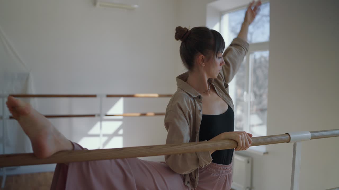 Dancer practicing at the barre in studio