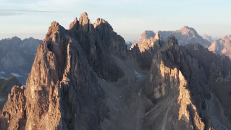 aerial orbiting shot of italian cadini di misurina mountain lighting by sunrise