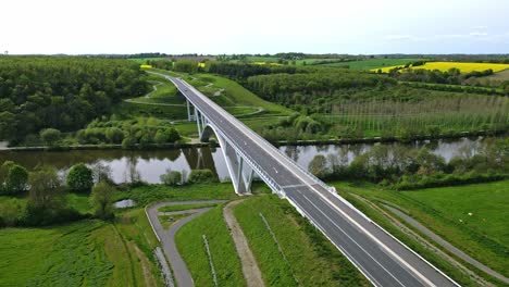 car driving on viaduct crossing mayenne river in chateau gontier countryside, france