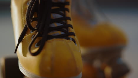 Closeup-yellow-roller-skates-with-details.-Female-skater-feet-in-rollerblades.