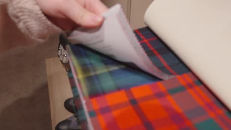 looking through samples of different tartan patterns and styles