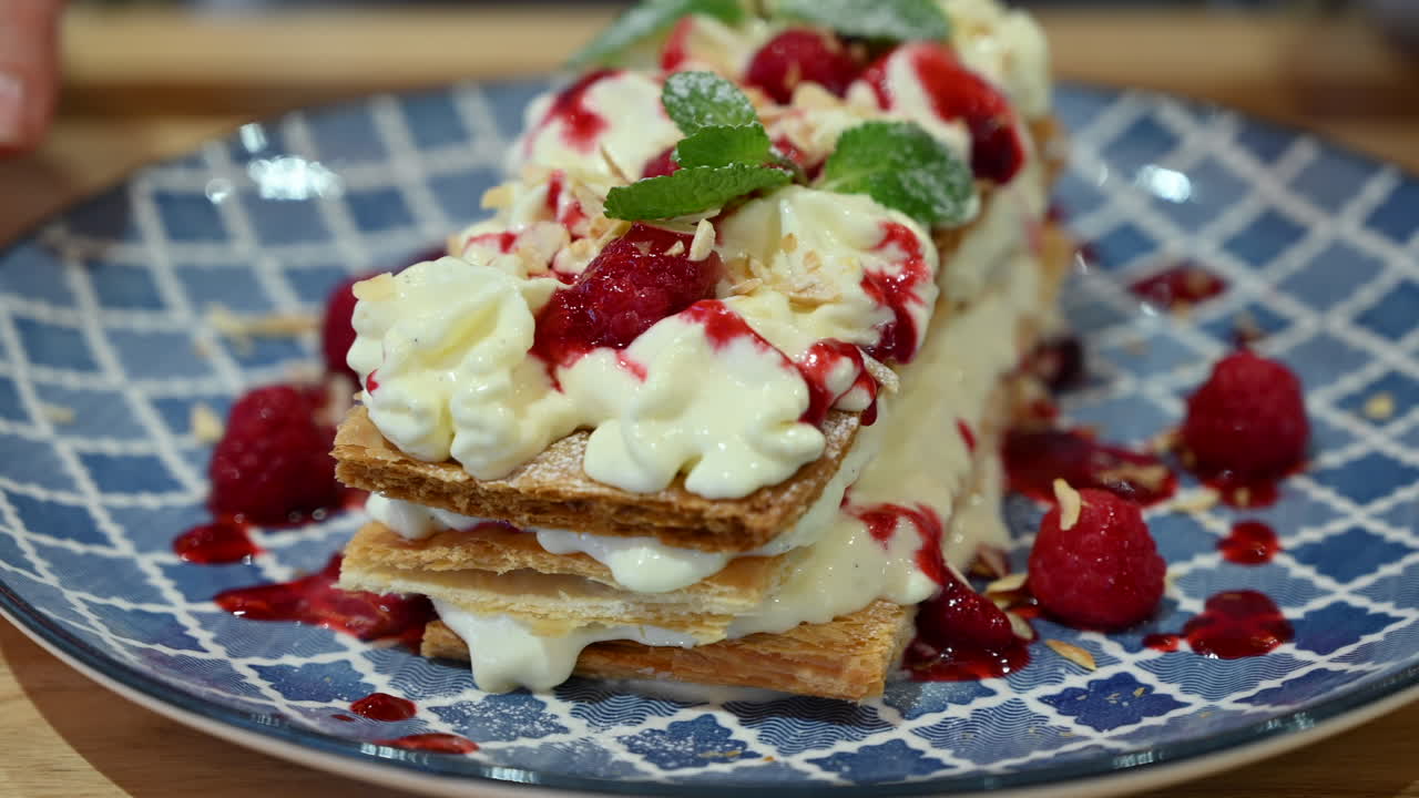 Millefeuille dessert at a restaurant in a blue plate