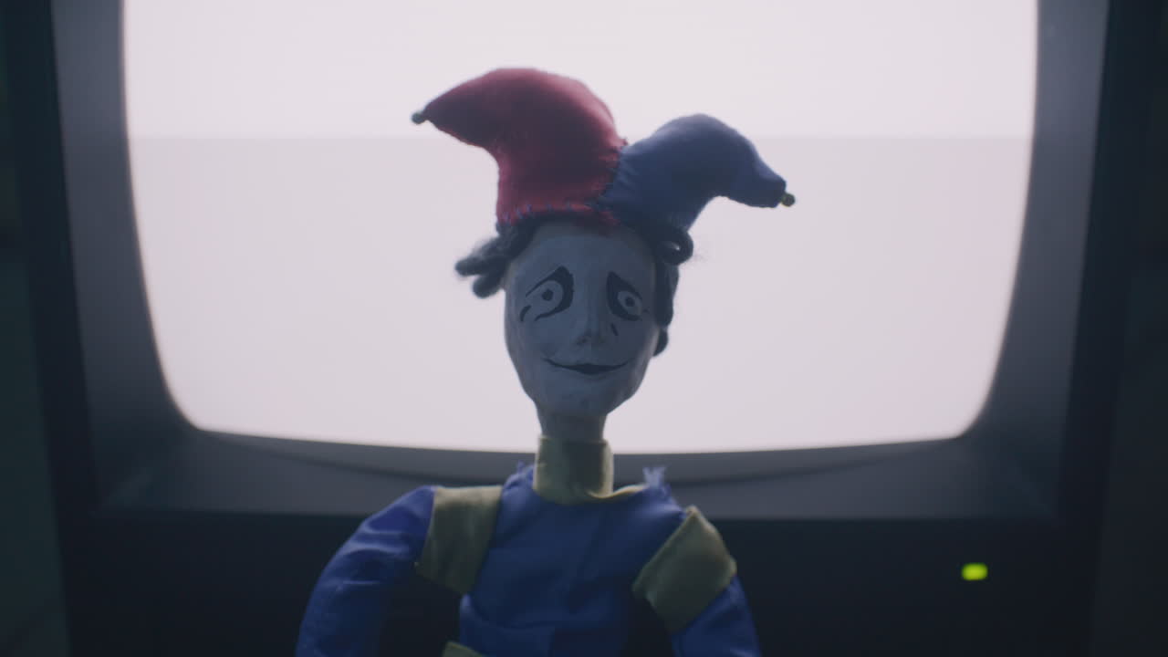 Creepy Jester Puppet in Front of a Vintage TV
