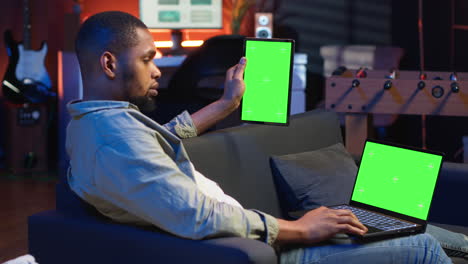 african american remote worker uses chroma key screen on gadget