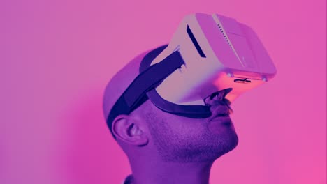 man experiencing virtual reality with a vr headset under neon lighting