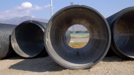 close view to the black plastic water pipe. big culvert for plumbing on the ground