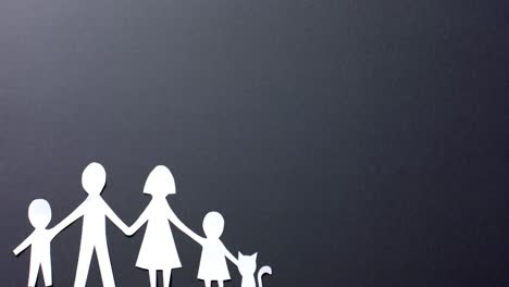 close up of family with cat made of white paper on gray background with copy space