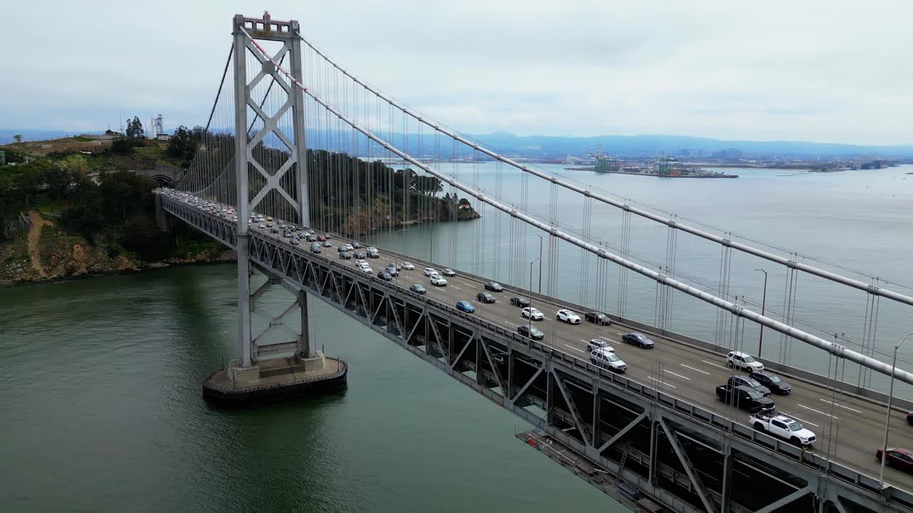 Drone flies over Oakland Bay Bridge with heavy car traffic (60fps)